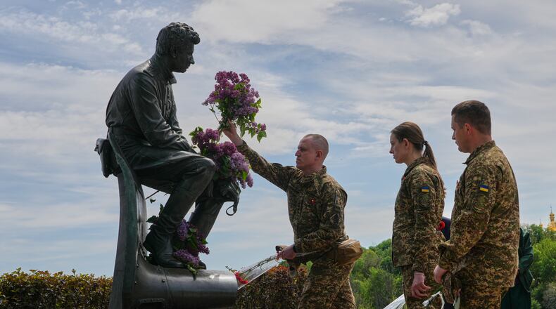 Ukrainian army officers lay flowers at a monument to pilots to mark Victory Day in World War II, in Kyiv, Ukraine, Friday, May 8, 2026, as the Russian attack on Ukraine continues. (AP Photo/Efrem Lukatsky)