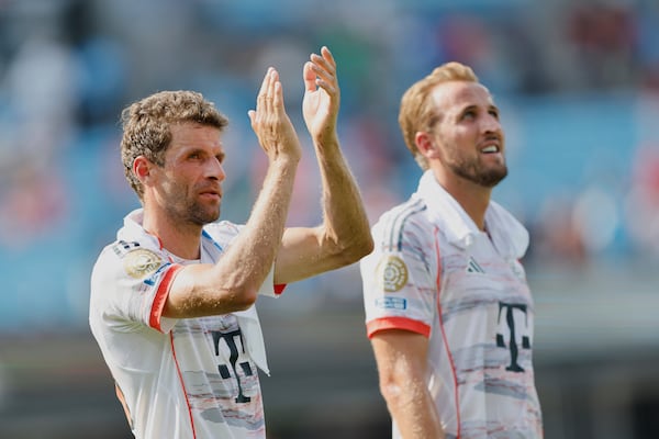Bayern Munich's Thomas Muller, left, and Harry Kane walk off the pitch after the Club World Cup Group C soccer match between Benfica and Bayern Munich in Charlotte, N.C., Tuesday, June 24, 2025. (AP Photo/Nell Redmond)