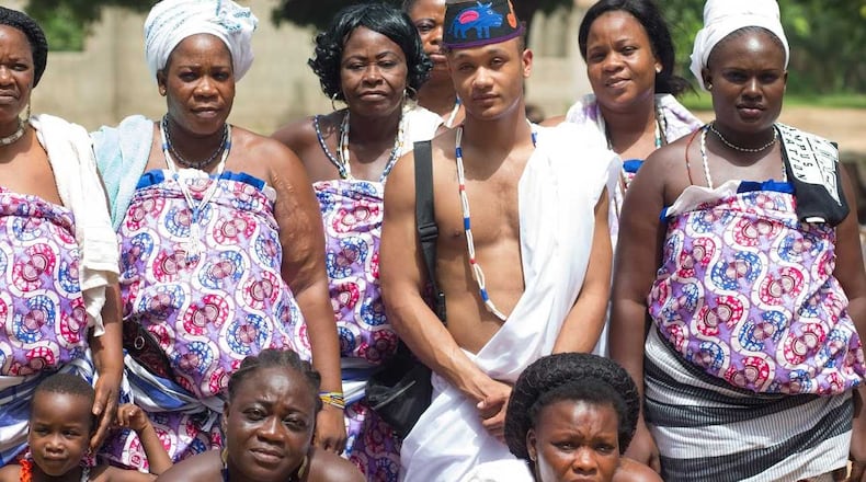Kieron Christian Graham stands with villagers from Benin, the African country from where his ancestors hail.