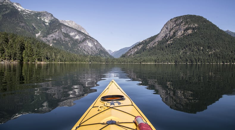 Paddling on Ross Lake, with Pumpkin Mountain at right. In the saddle is the Big Beaver Creek trail in North Cascades National Park. (Steve Ringman/Seattle Times/TNS)