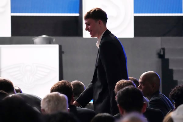 Duke's Cooper Flagg walks back to his seat after he was interviewed by ESPN after the Dalas Mavericks won the first pick in the NBA basketball draft lottery in Chicago, Monday, May 12, 2025. (AP Photo/Nam Y. Huh)
