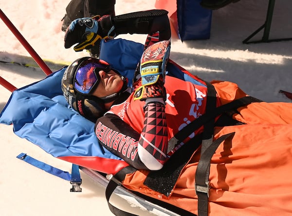 Italy's Federica Brignone is carried away on a toboga after she broke multiple bones in her left leg during a giant slalom crash at the Italian championships in the Lusia ski area, in Val di Fassa, Italy, Thursday, April 3, 2025. (AP Photo/Elvis Piazzi)