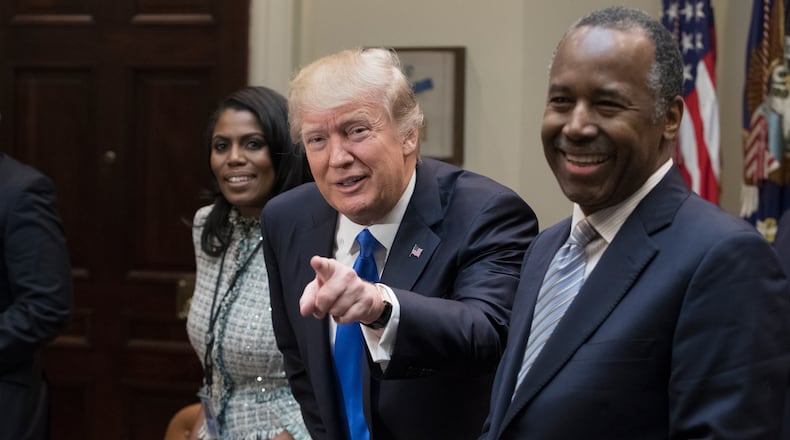 WASHINGTON, DC - FEBRUARY 1: President Donald Trump holds an African American History Month listening session attended by nominee to lead the Department of Housing and Urban Development (HUD) Ben Carson (R), Director of Communications for the Office of Public Liaison Omarosa Manigault (L) and other officials in the Roosevelt Room of the White House on February 1, 2017 in Washington, DC. (Photo by Michael Reynolds - Pool/Getty Images)