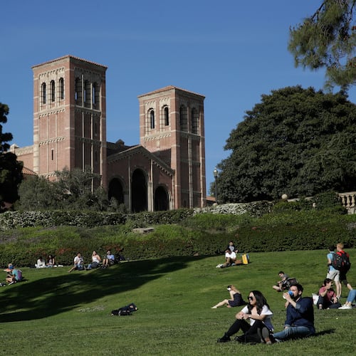 FILE - Students sit on the lawn near Royce Hall at UCLA in the Westwood section of Los Angeles on April 25, 2019. (AP Photo/Jae C. Hong, File)