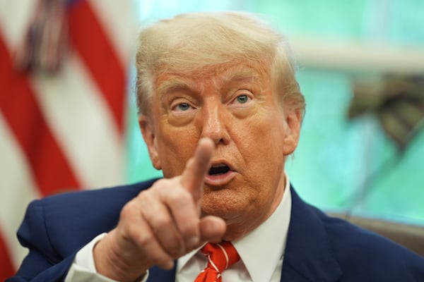 President Donald Trump gestures as he speaks with reporters after announcing a trade deal with United Kingdom in the Oval Office of the White House, Thursday, May 8, 2025, in Washington. (AP Photo/Evan Vucci)