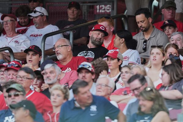 David Burns, center left, and Trinetti Burns, center right, parents of Cincinnati Reds pitcher Chase Burns, sit in the stands during the seventh inning of a baseball game against the New York Yankees, Tuesday, June 24, 2025, in Cincinnati. (AP Photo/Joshua A. Bickel)