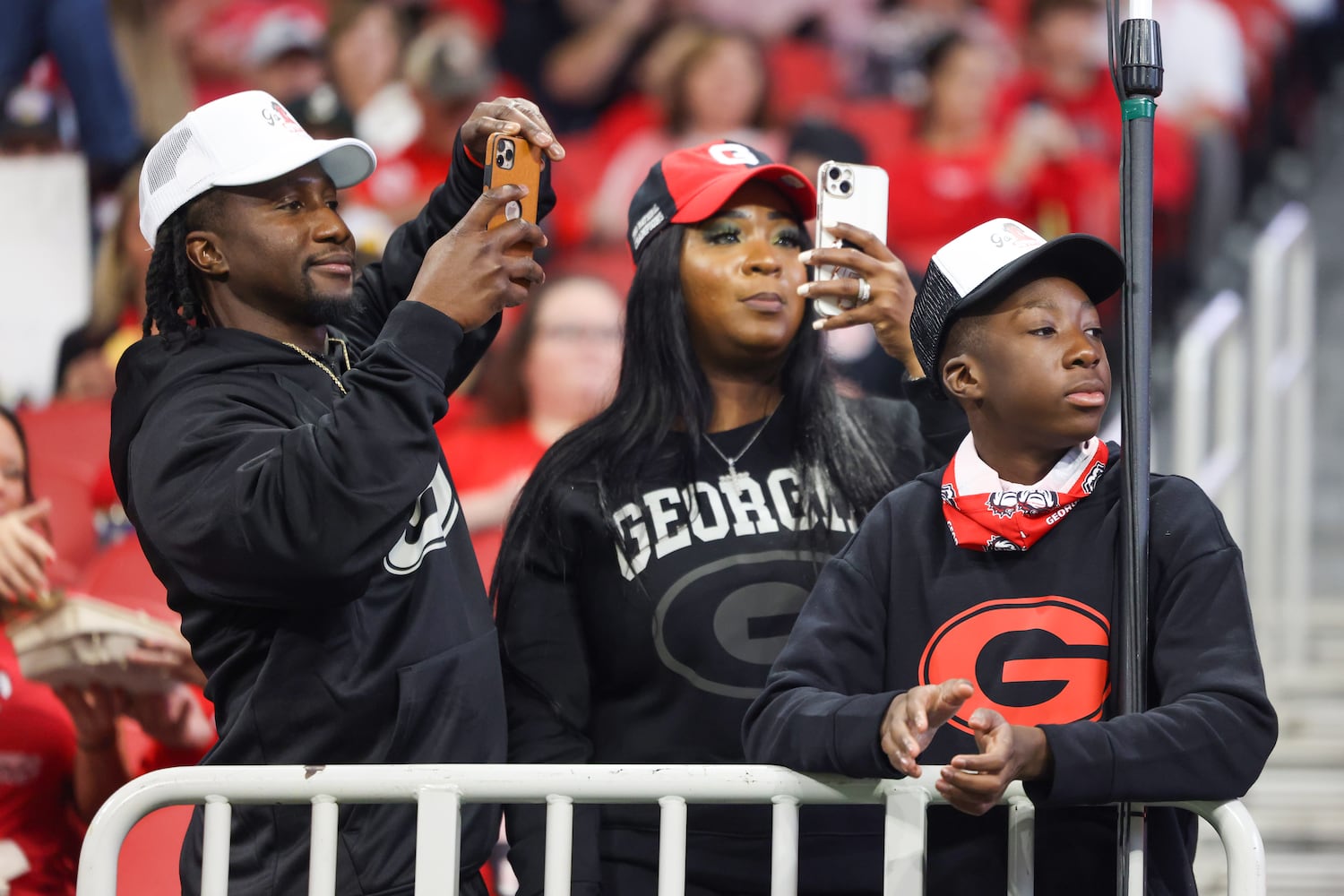 Georgia Bulldog fans document the team entering the field during before facing the LSU Tigers in the SEC Championship Game at Mercedes-Benz Stadium in Atlanta on Saturday, Dec. 3, 2022. (Jason Getz / Jason.Getz@ajc.com)