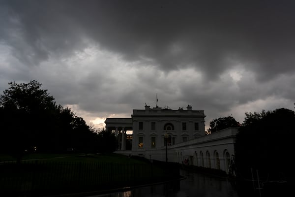 Dark clouds hover over the White House as a front of rain moves through, Monday, July 14, 2025, in Washington. (AP Photo/Alex Brandon)