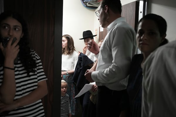People take shelter during sirens warning of incoming fire at Israel's Magen David Adom emergency service during a blood drive to prepare for mass casualties in the event of strikes by Iran, in Jerusalem, Saturday, June 14, 2025. (AP Photo/Maya Alleruzzo)