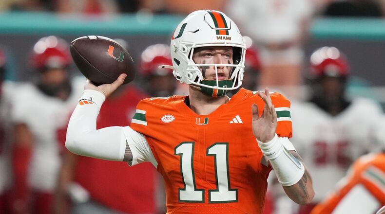 Miami quarterback Carson Beck (11) throws during the second half of an NCAA college football game against North Carolina State, Saturday, Nov. 15, 2025, in Miami Gardens, Fla. (AP Photo/Lynne Sladky)