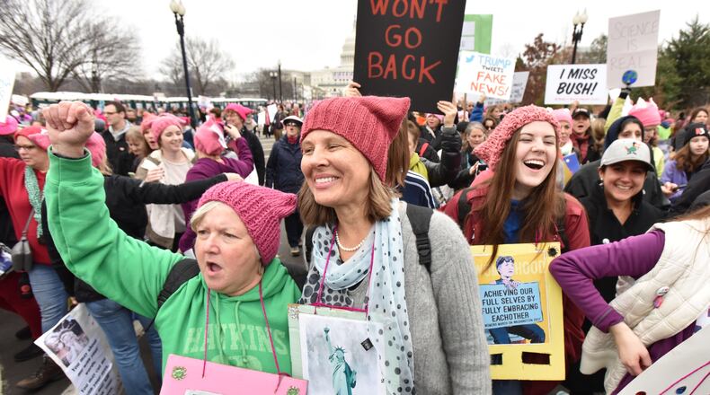 January 21, 2017 Washington D.C. - A group from Decatur, from left, Kay Hinton and Lynn Adams, and Katie Adams, 18, walk toward the U.S. Capitol for the Women’s March on Washington on Saturday, January 21, 2017. They rode a bus overnight to participate this event. The Women’s March on Washington is a grassroots effort comprised of dozens of independent coordinators at the state level. HYOSUB SHIN / HSHIN@AJC.COM