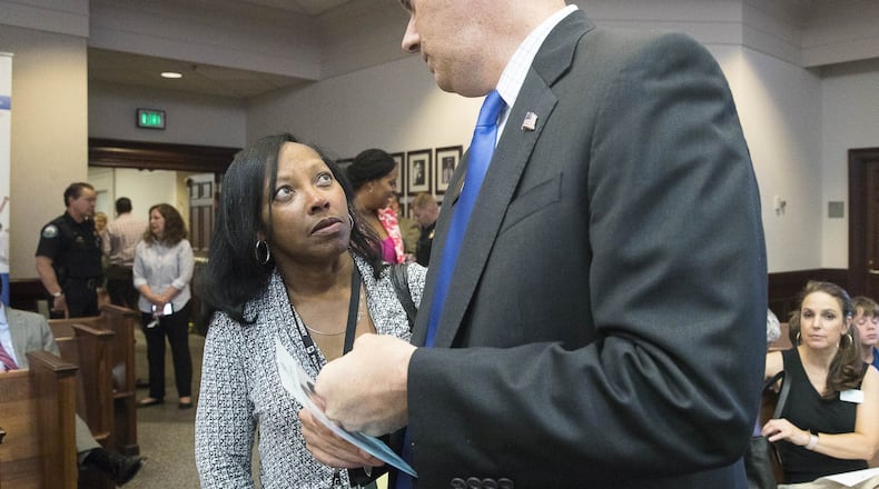 Lynnette Allen (left), Fulton County’s new opioid coordinator, speaks with Fulton Commissioner Bob Ellis (right) before the start of an opioid crisis forum in the Roswell City Council Chambers, Tuesday, June 26, 2018. ALYSSA POINTER/ALYSSA.POINTER@AJC.COM