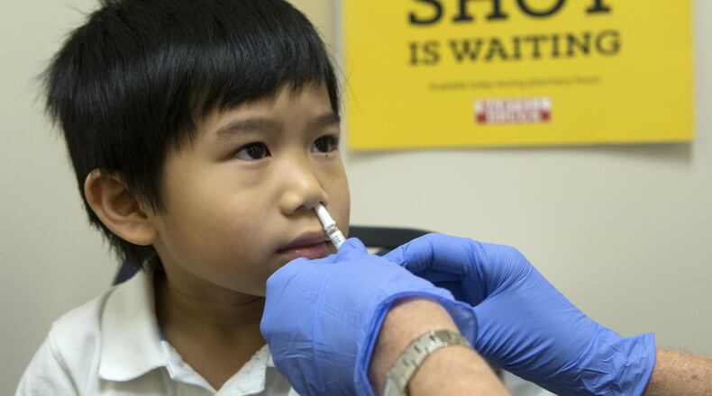 Brayden Yee, 5, of Shoreline, Wash., receives a dose of FluMist from a Bartell Drugs pharmacist. (Ellen M. Banner/Seattle Times/TNS)