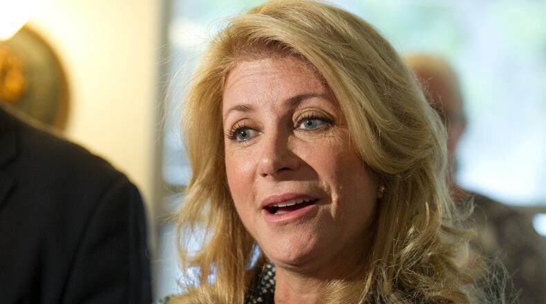 Texas gubernatorial candidate Wendy Davis talks to reporters after giving a pep talk to campaign volunteers at the north Austin home of Jim Bryce on the eve of the election on Monday November 3, 2014. JAY JANNER / AMERICAN-STATESMAN
