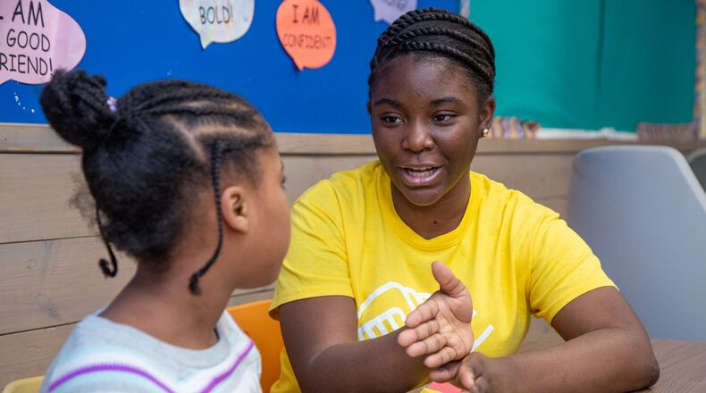 Kimberly Heard (right) helps 8-year-old Brooklyn DeBerry with homework at the A.R. “Gus” Barksdale Boys & Girls Club in Conyers in this AJC file photo. Boys & Girls Clubs across the state will share $15 million in funding to help students with learning loss suffered during the pandemic. (Photo by Phil Skinner)