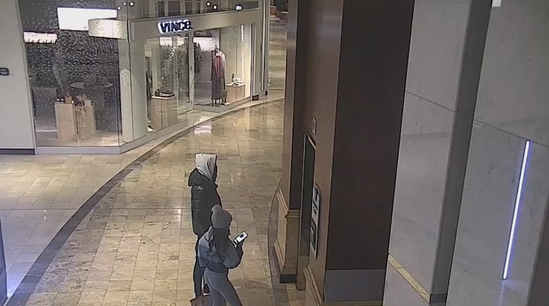 Security camera footage from Phipps Plaza shows a couple who police believe were involved in a shooting at the theater there.