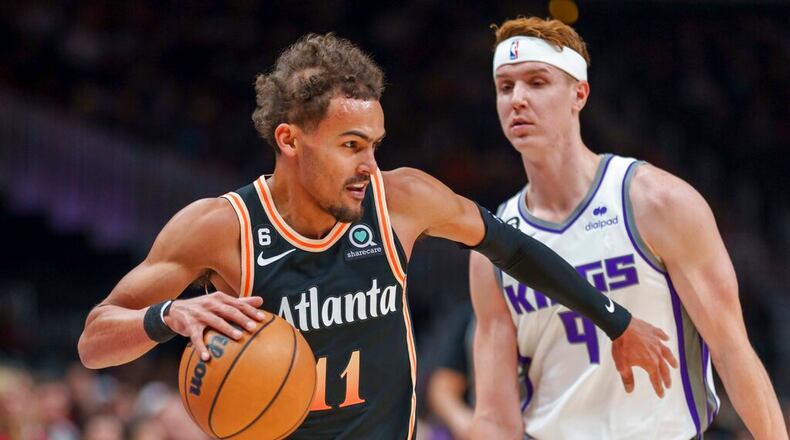 Atlanta Hawks guard Trae Young (11) drives against Sacramento Kings guard Kevin Huerter (9) during the first half of an NBA basketball game on Wednesday, Nov. 23, 2022, in Atlanta. (AP Photo/Erik Rank)