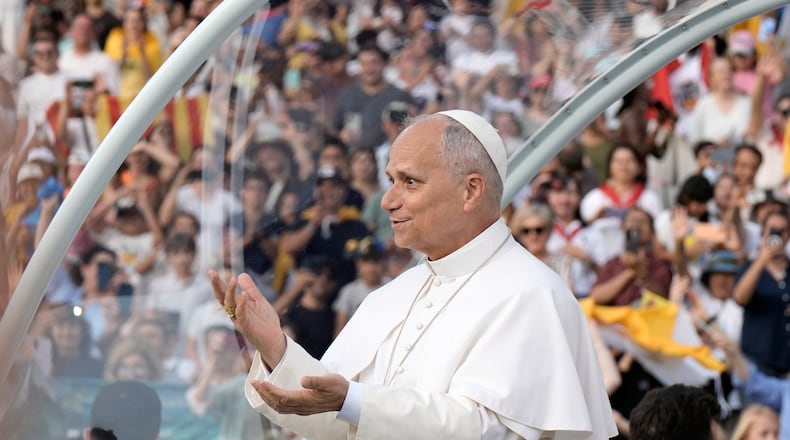 Pope Leo XIV makes a six-seven hand gestures as he arrives to attend a prayer vigil at Lluis Companys Olympic Stadium in Barcelona, Spain, Tuesday, June 9, 2026. (AP Photo/Bernat Armangue)