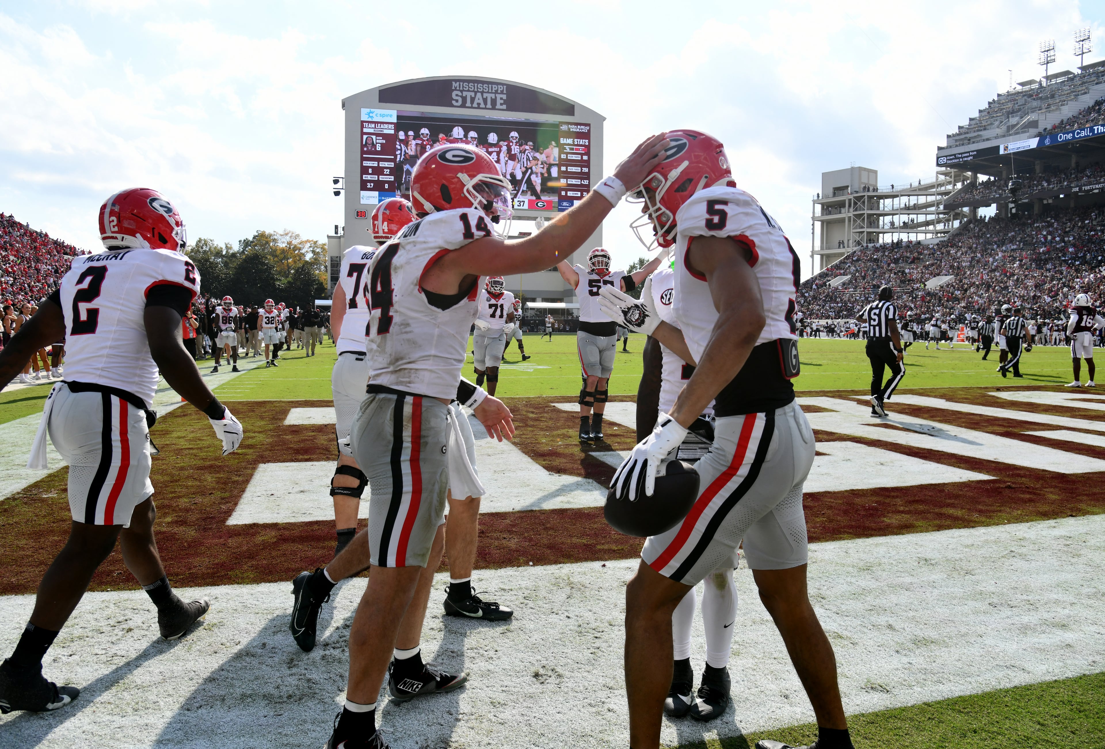 Georgia wide receiver Noah Thomas (5) celebrates with Georgia quarterback Gunner Stockton (14) after scoring a touchdown during the second half in an NCAA football game at Davis Wade Stadium, Saturday, November 8, 2025, in Starkville, Mississippi. Georgia won 41-21 over Mississippi State. (Hyosub Shin / AJC)