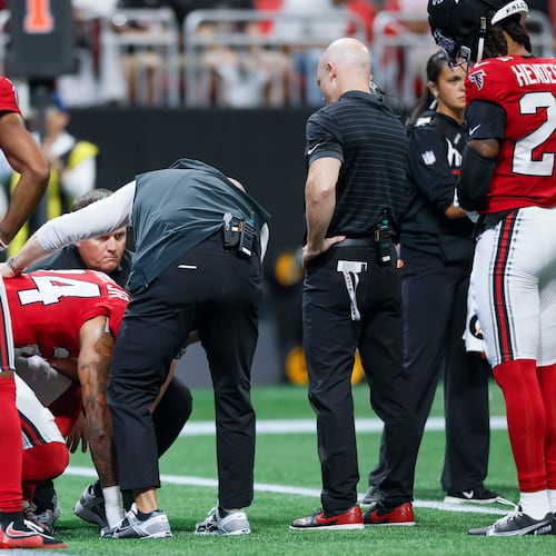 Atlanta Falcons cornerback A.J. Terrell Jr. (24) receives assistance from the medical staff after an injury timeout in the first half of an NFL game against the Carolina Panthers at Mercedes-Benz Stadium in Atlanta on Sunday, Sept. 20, 2026. (Miguel Martinez/AJC)