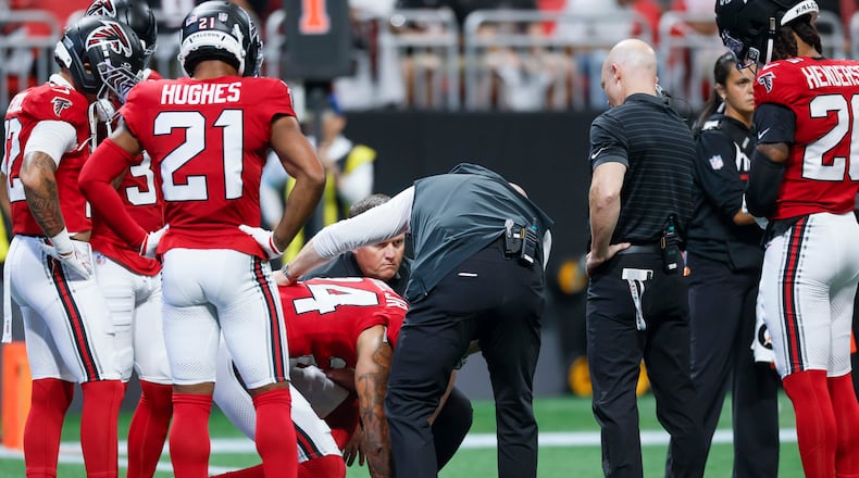 Atlanta Falcons cornerback A.J. Terrell Jr. (24) receives assistance from the medical staff after an injury timeout in the first half of an NFL game against the Carolina Panthers at Mercedes-Benz Stadium in Atlanta on Sunday, Sept. 20, 2026. (Miguel Martinez/AJC)
