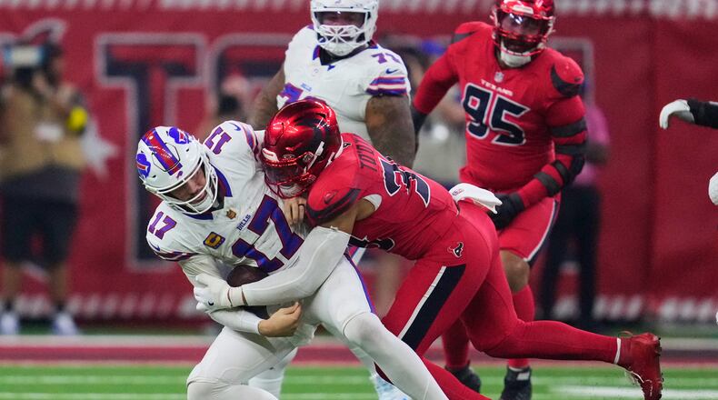 Buffalo Bills quarterback Josh Allen (17) is sacked by Houston Texans linebacker Henry To'oTo'o (39) in the second half of an NFL football game Thursday, Nov. 20, 2025, in Houston. (AP Photo/Ashley Landis)
