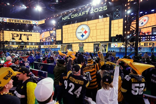 Pittsburgh Steelers fans cheer as their team announces a pick during the third round of the NFL football draft, Friday, April 25, 2025, in Green Bay, Wis. (AP Photo/Matt Ludtke)