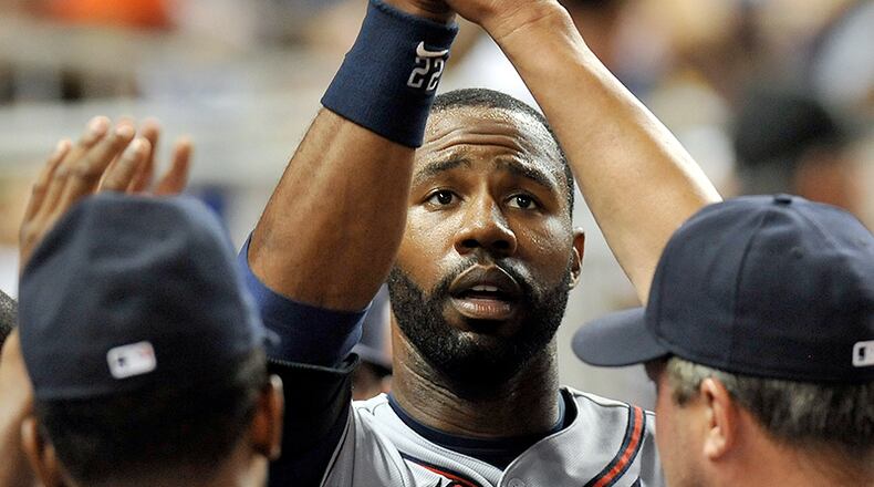 Braves right fielder Jason Heyward celebrates with teammates after scoring a run during the sixth inning Monday against the Miami Marlins at Marlins Park in Miami.