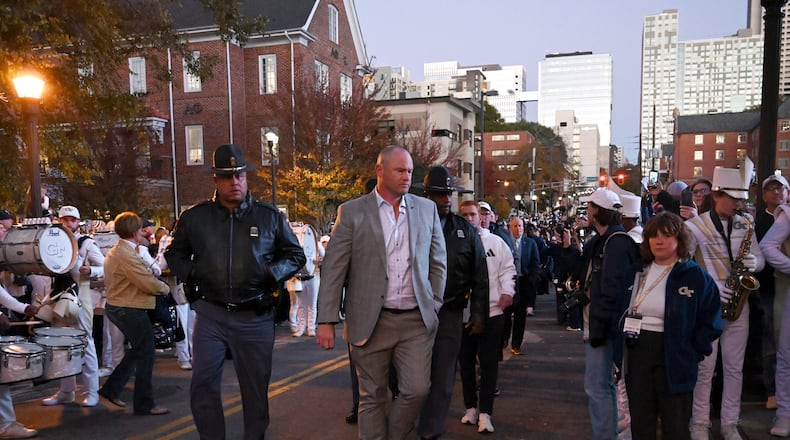 Georgia Tech coach Brent Key and players participate in Yellow Jacket Alley before an NCAA college football game between Georgia Tech and North Carolina State at Bobby Dodd Stadium, Thursday, November 21, 2024, in Atlanta. (Hyosub Shin / AJC)