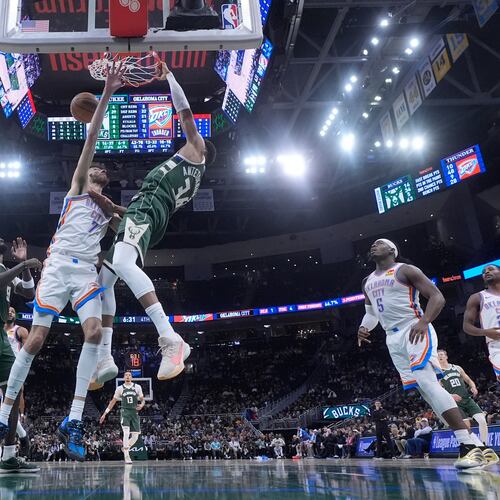 Milwaukee Bucks' Giannis Antetokounmpo dunks over Oklahoma City Thunder's Chet Holmgren during the second half of an NBA basketball game Wednesday, Jan. 21, 2026, in Milwaukee. (AP Photo/Morry Gash)