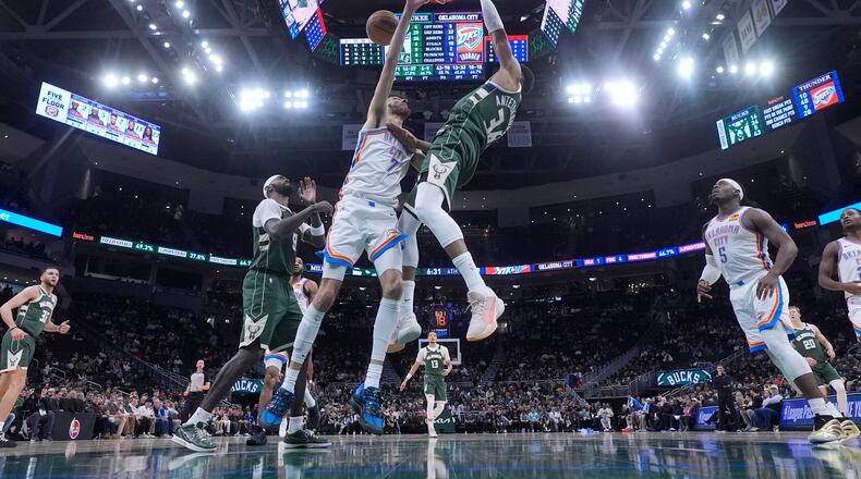 Milwaukee Bucks' Giannis Antetokounmpo dunks over Oklahoma City Thunder's Chet Holmgren during the second half of an NBA basketball game Wednesday, Jan. 21, 2026, in Milwaukee. (AP Photo/Morry Gash)