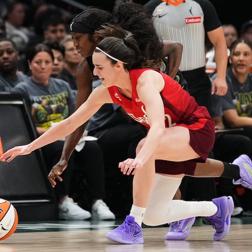 Seattle Storm guard Flau'jae Johnson, back, reaches for the ball against Indiana Fever guard Caitlin Clark, front, during the second half of a WNBA basketball game, Tuesday, July 28, 2026, in Seattle. (AP Photo/Lindsey Wasson)