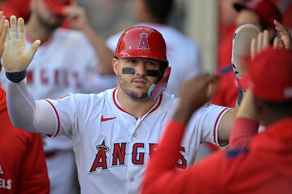 Los Angeles Angels' Mike Trout is greeted in the dugout after scoring a run during the first inning of a baseball game against the Boston Red Sox, Monday, June 23, 2025, in Anaheim, Calif. (Jayne Kamin-Oncea/AP)