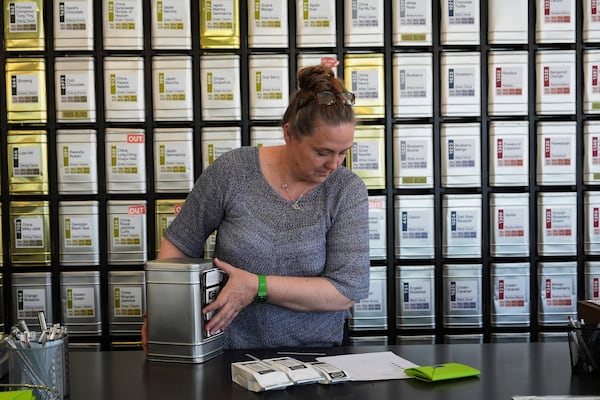 Owner Lisa McDonald packages a loose leaf tea orders at the TeaHaus Thursday, April 24, 2025, in Ann Arbor, Mich. (AP Photo/Paul Sancya)