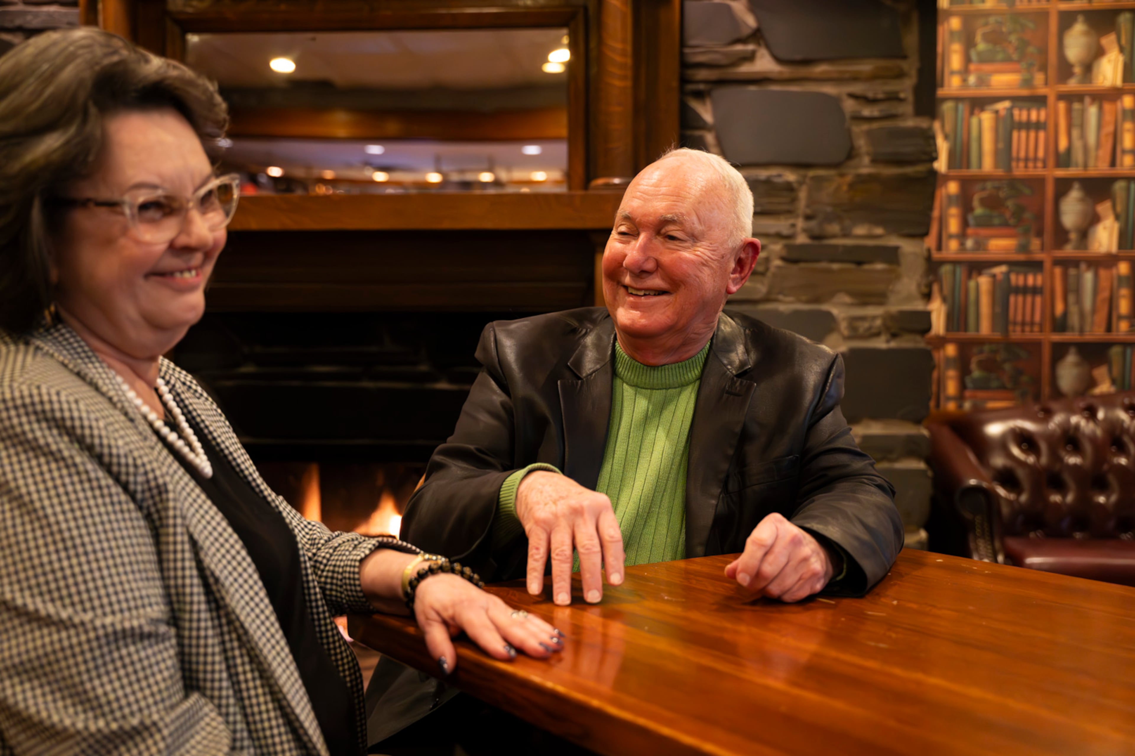 Dr. Patrick O'Neal, a regular at The Colonnade, chats with longtime friend and server Rhea Merritt, who now works the front of the house, last year at The Colonnade. For nearly a century, the restaurant has been a beacon of Southern comfort on Atlanta’s Cheshire Bridge Road. (Olivia Bowdoin for the AJC 2024)