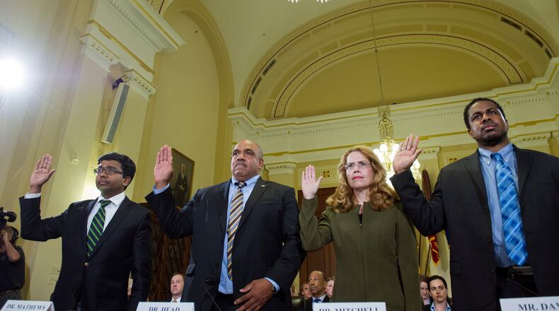 From left; Jose Mathews, M.D., former chief of psychiatry, St. Louis VA Health Care System; Christian Head, M.D., associate director, chief of staff, Legal and Quality Assurance, Greater Los Angeles VA Health Care System; Katherine Mitchell, M.D., medical director, Iraq and Afghanistan Post-Deployment Center, Phoenix VA Health Care System; and Scott Davis, program specialist, VA National Health Eligibility Center, are sworn-in to testify before the House Veterans’ Affairs Committee hearing on the Department of Veteran Affairs supplying inadequate services, on Capitol Hill in Washington, Tuesday, July 8, 2014. AP Photo / Cliff Owen