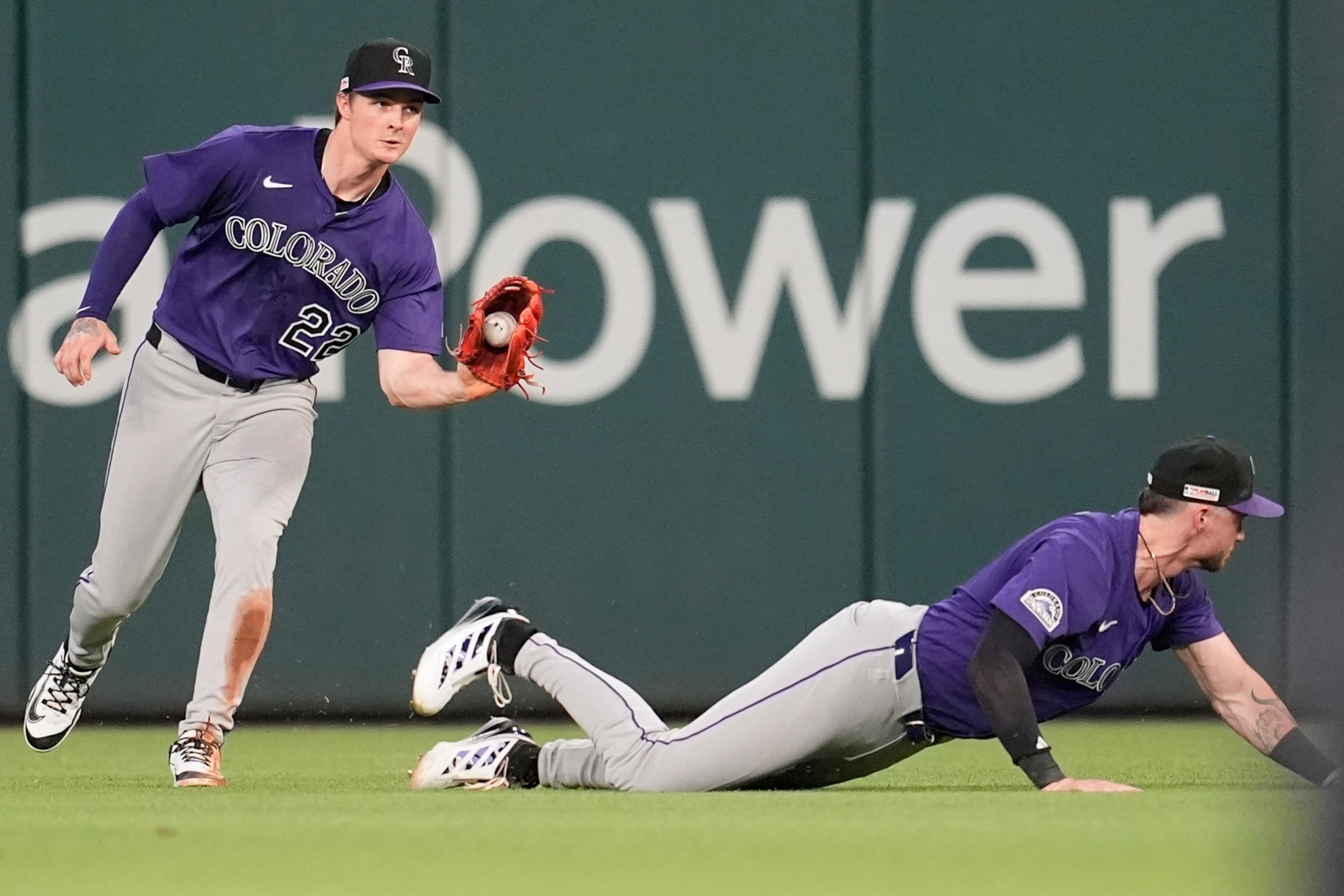 Rockies outfielder Mickey Moniak (22) catches a hit by the Braves' Ronald Acuña Jr. during the fifth inning of Friday's baseball game in Atlanta. (Mike Stewart/AP)