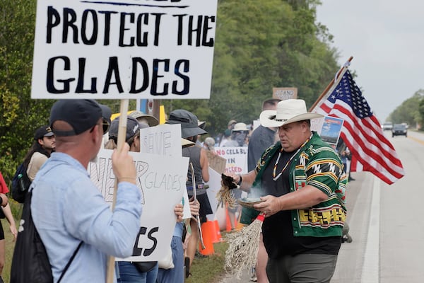 Gary Wilcox with the American Indian movement blesses and cleanses environmental advocates and protesters at the Dade-Collier Training and Transition Airport on Tamiami Trail E, Ochopee, Fla., on Saturday, June 28, 2025. (Mike Stocker /South Florida Sun-Sentinel via AP)