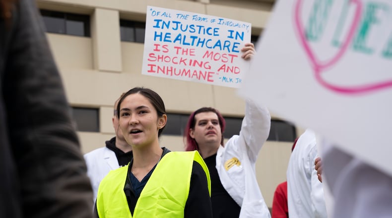 Protesters march on Nov. 12 in front of Atlanta Medical Center, calling for expanded access to Medicaid in Georgia. (Olivia Bowdoin for The Atlanta Journal-Constitution)