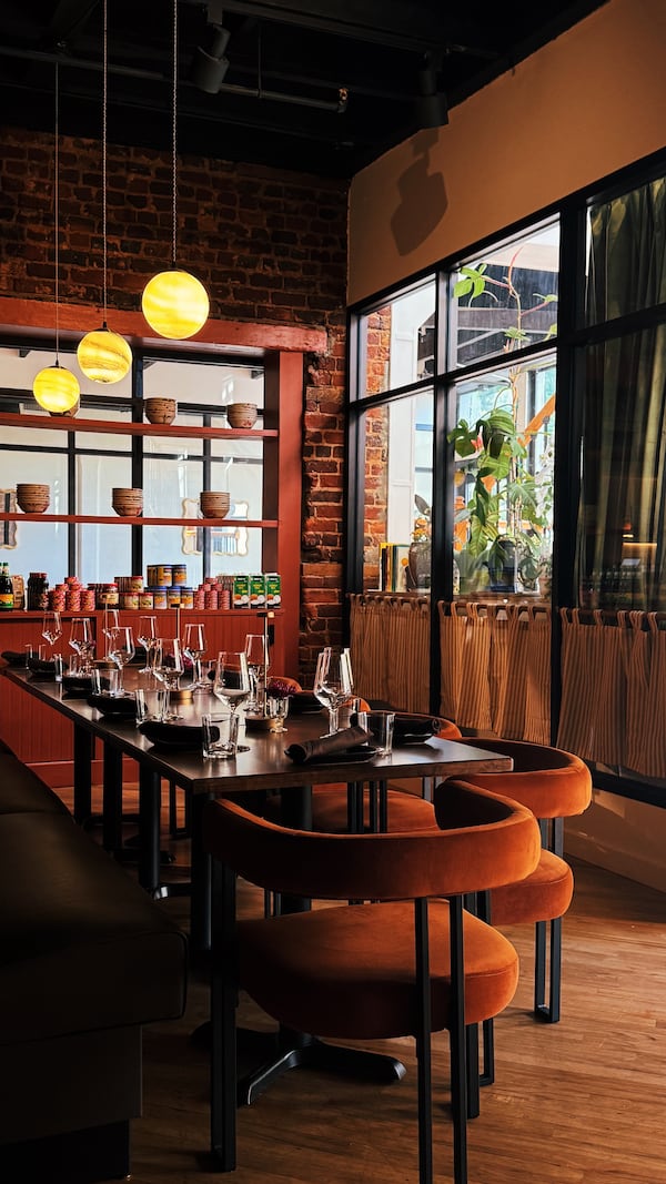 Tipsy Thaiger leans into the aesthetic of its historic Roswell building, highlighting hardwood floors and exposed brick. (Courtesy of Angie Webb/Tipsy Thaiger)