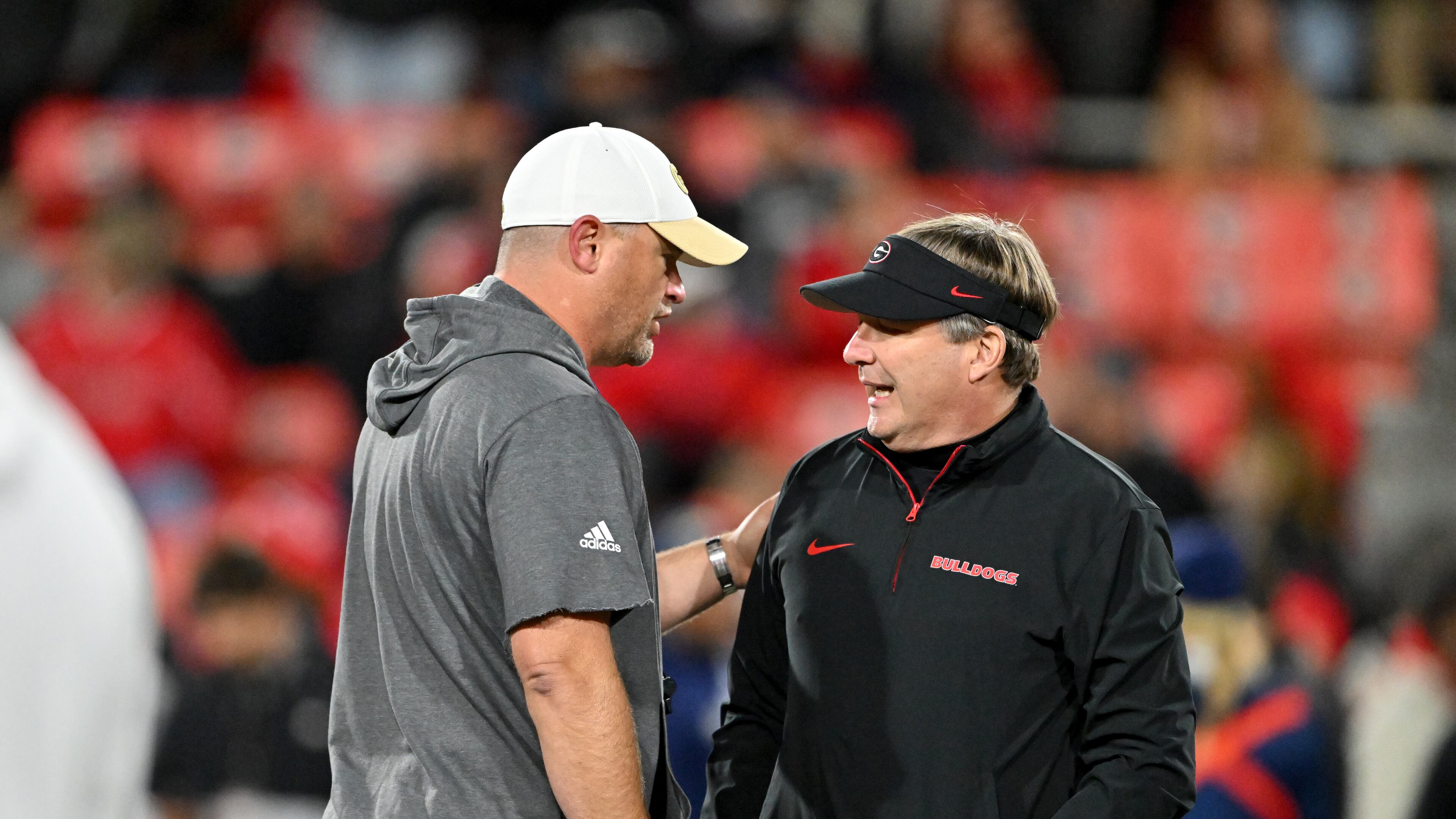 Georgia Tech head coach Brent Key (left) and Georgia head coach Kirby Smart chat before an NCAA football game between Georgia and Georgia Tech at Sanford Stadium in Athens. (Hyosub Shin / AJC 2024)