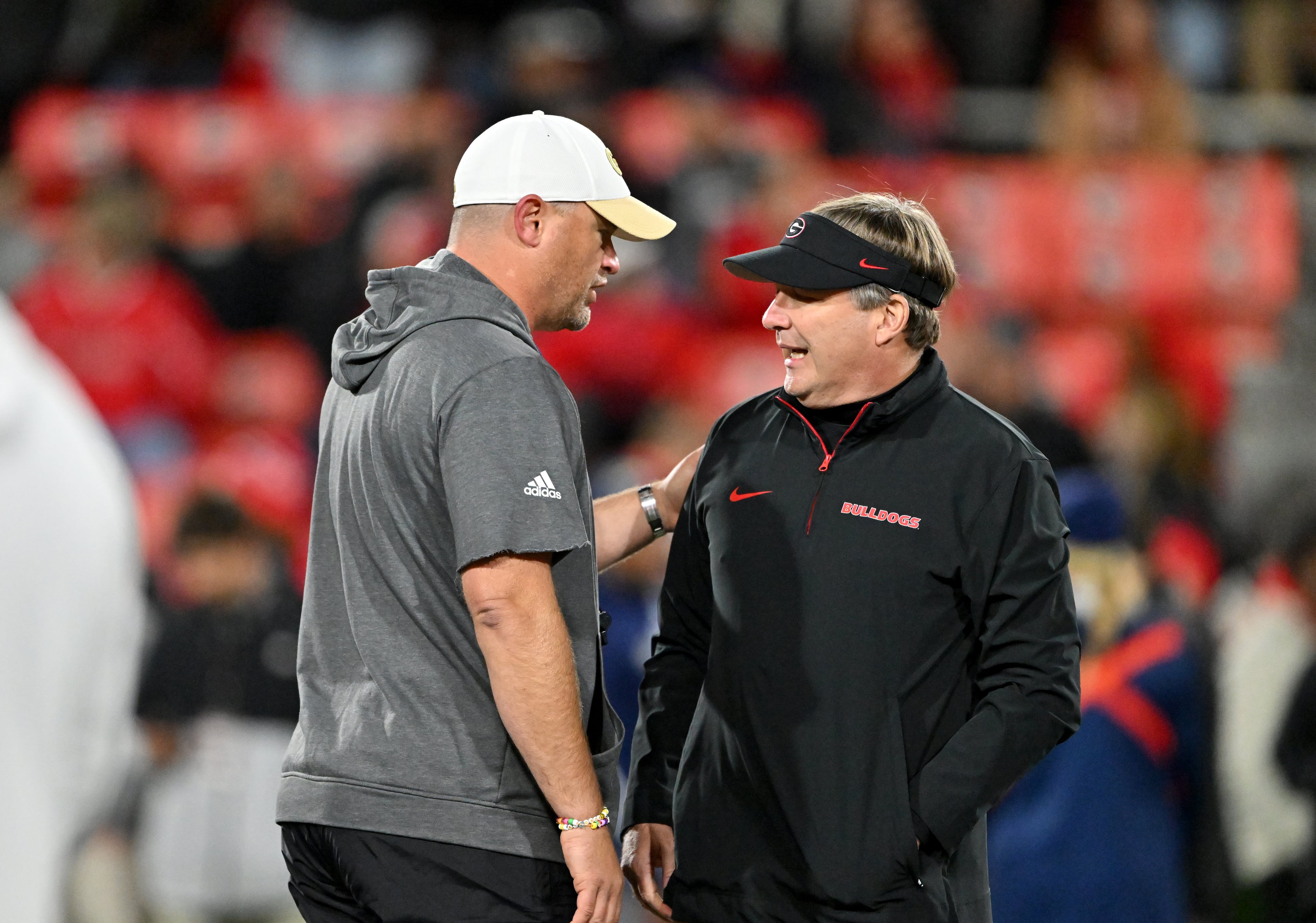 Georgia Tech head coach Brent Key (left) and Georgia head coach Kirby Smart chat before an NCAA football game between Georgia and Georgia Tech at Sanford Stadium in Athens. (Hyosub Shin / AJC 2024)
