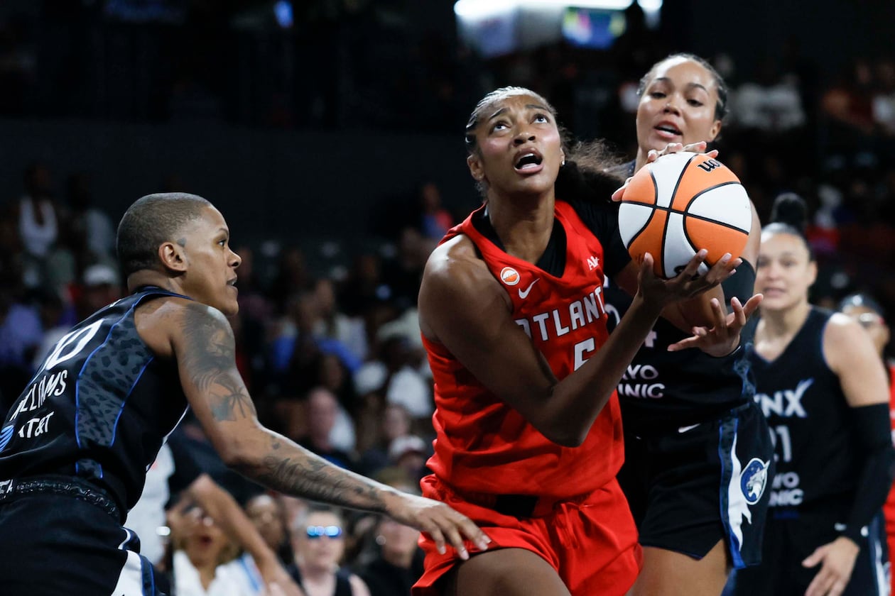 Atlanta Dream forward Angel Reese (center) goes up for a basket against Minnesota Lynx guard Courtney Williams (left) in the first half of a WNBA game at Gateway Center Arena on Sunday, Aug. 30, 2026, in Atlanta. (Miguel Martinez/ AJC)