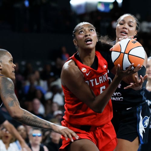 Atlanta Dream forward Angel Reese (center) goes up for a basket against Minnesota Lynx guard Courtney Williams (left) in the first half of a WNBA game at Gateway Center Arena on Sunday, Aug. 30, 2026, in Atlanta. (Miguel Martinez/ AJC)