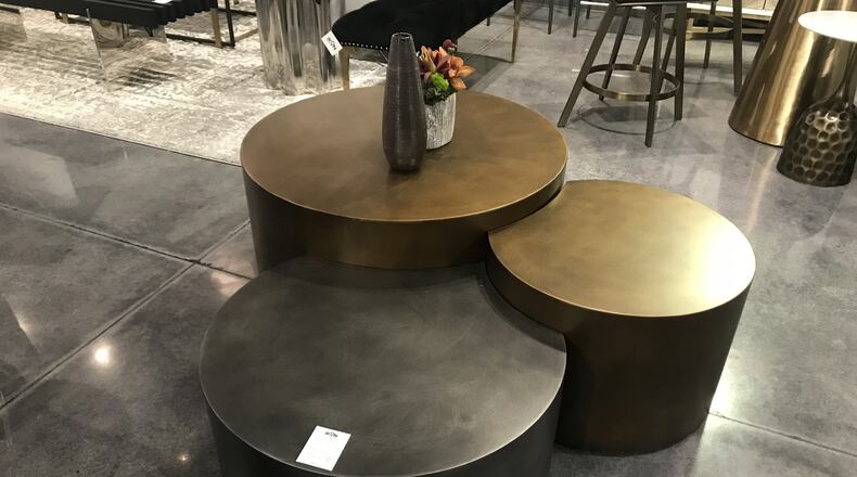 Interlocking black and brass tables make a modern and pimactful statement. (Design Recipes)