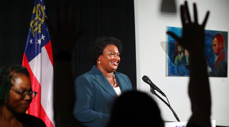 A supporter waves as Democratic nominee for Governor Stacey Abrams concludes her economic address outlining her vision for Georgia’s economy earlier this month in Atlanta. In recent years, Abrams has amassed a lucrative portfolio of business deals and investments that could present potential conflicts if she is elected. (Curtis Compton / Curtis Compton@ajc.com)