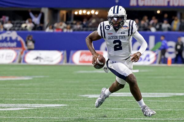 Jackson State Tigers quarterback Shedeur Sanders (2) rolls out and scores a rushing touchdown in the second quarter against North Carolina Central in the Celebration Bowl at Mercedes-Benz Stadium, Saturday, Dec. 17, 2022, in Atlanta. (Jason Getz / AJC)