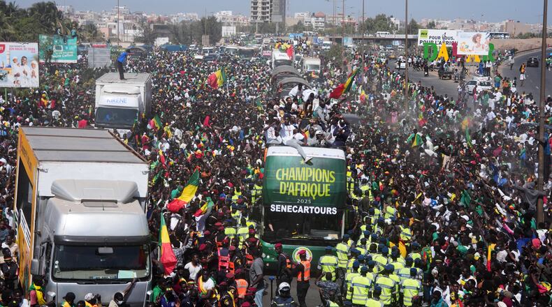 The Senegalese soccer team rides through thousands of cheering fans celebrating their victory in the Africa Cup of Nations soccer tournament, in Dakar, Senegal, Tuesday, Jan. 20, 2026. (AP Photo/Misper Apawu)