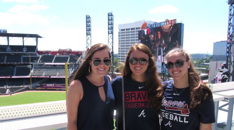 Isabelle Gordon, left, Hannah Berretta and Hannah Lagod pose in front of the SunTrust Park sign while they can. Photo: Jennifer Brett, jbrett@ajc.com