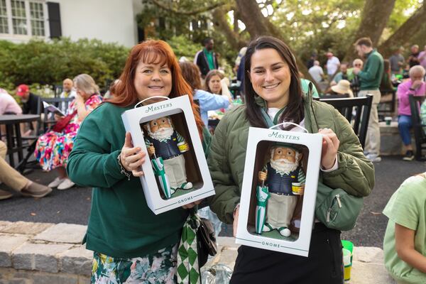 Patrons Karen Neubauer, left, from Richmond, Va., and Justine Dutton, from Raleigh, N.C. hold their Masters gnomes purchased at the golf shop during a practice round at the Masters golf tournament, Monday, April 6, 2026, in Augusta, Ga. (Jason Getz/AJC) 